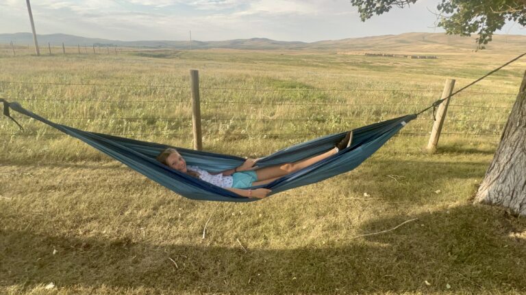 Laying in hammock on cattle ranch near East Glacier National Park