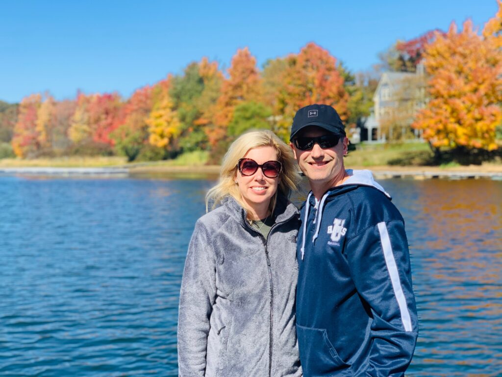 Lakegoers in front of colorful fall trees at Deep Creek Lake