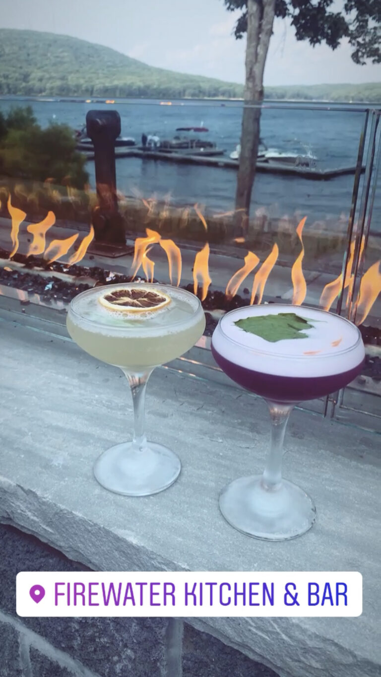 cocktails in front of fire table overlooking deep creek lake