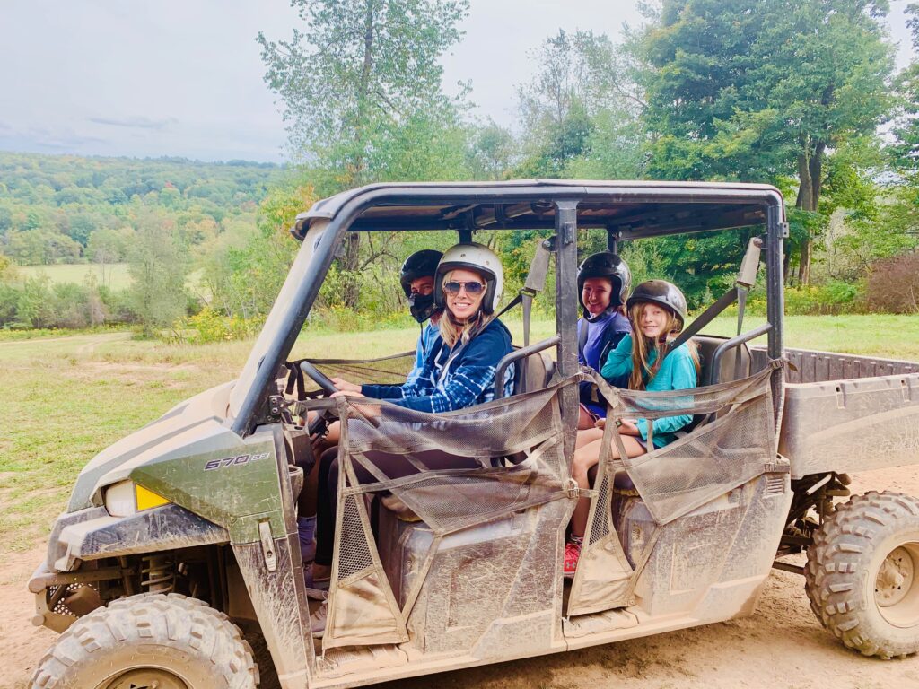 family riding an ATV in fall