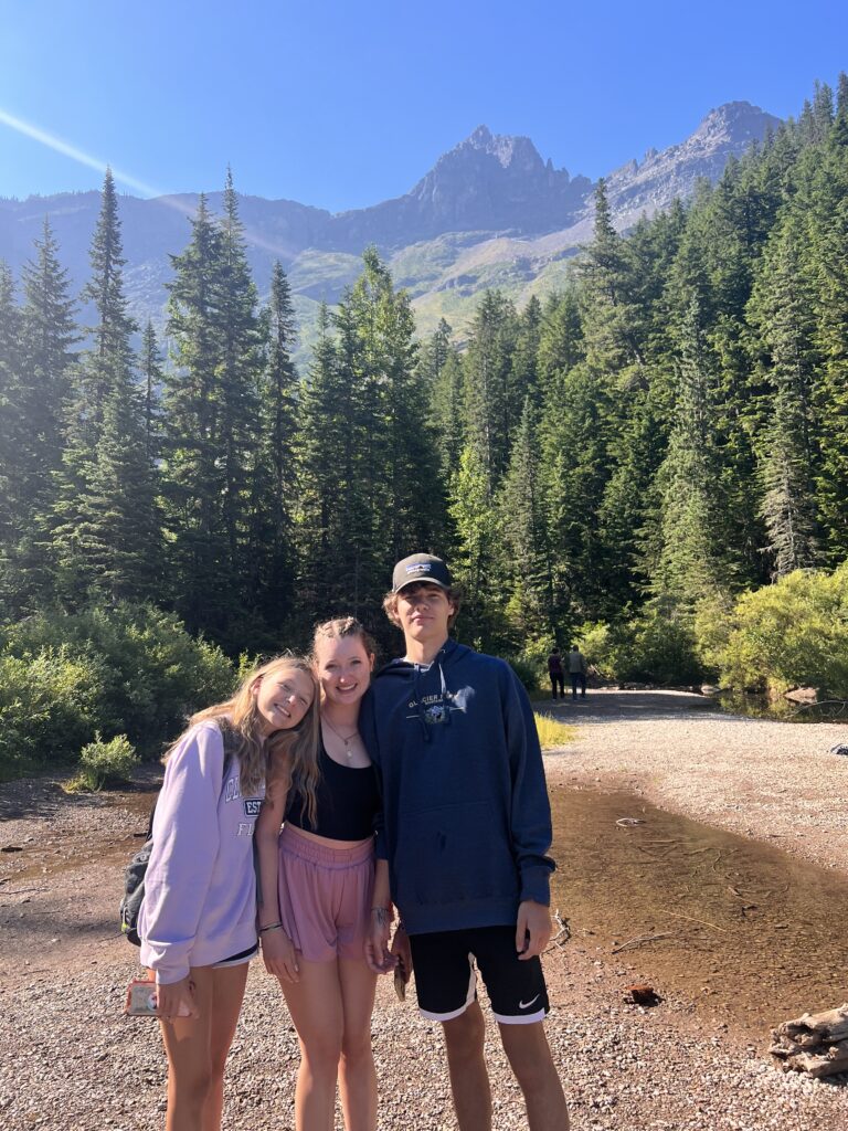 Hikers on beach at Avalanche Lake in Glacier National Park