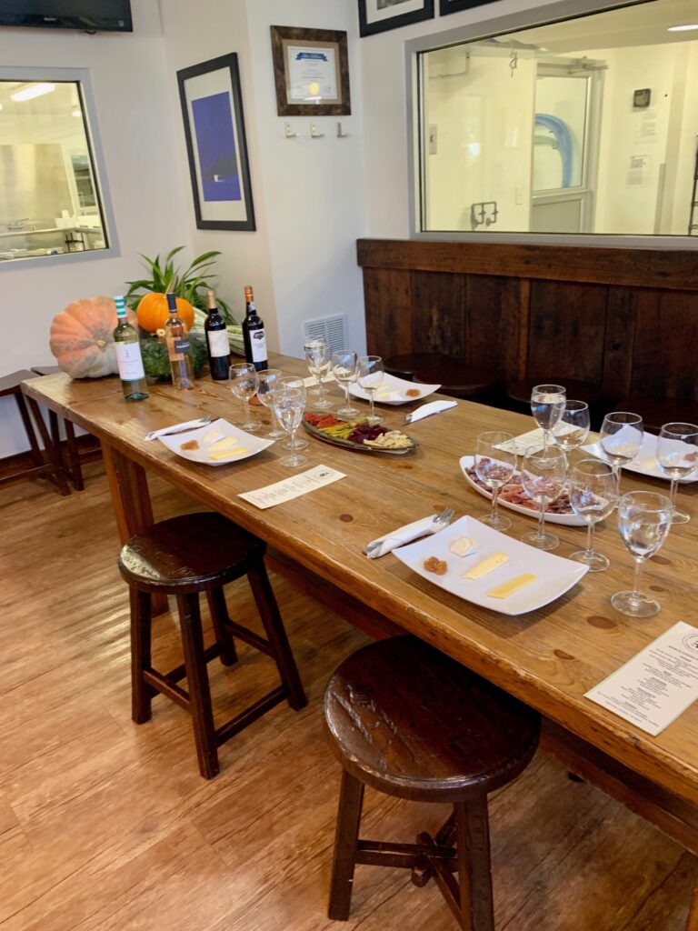 table with wine glasses, cheese plates and fall decor