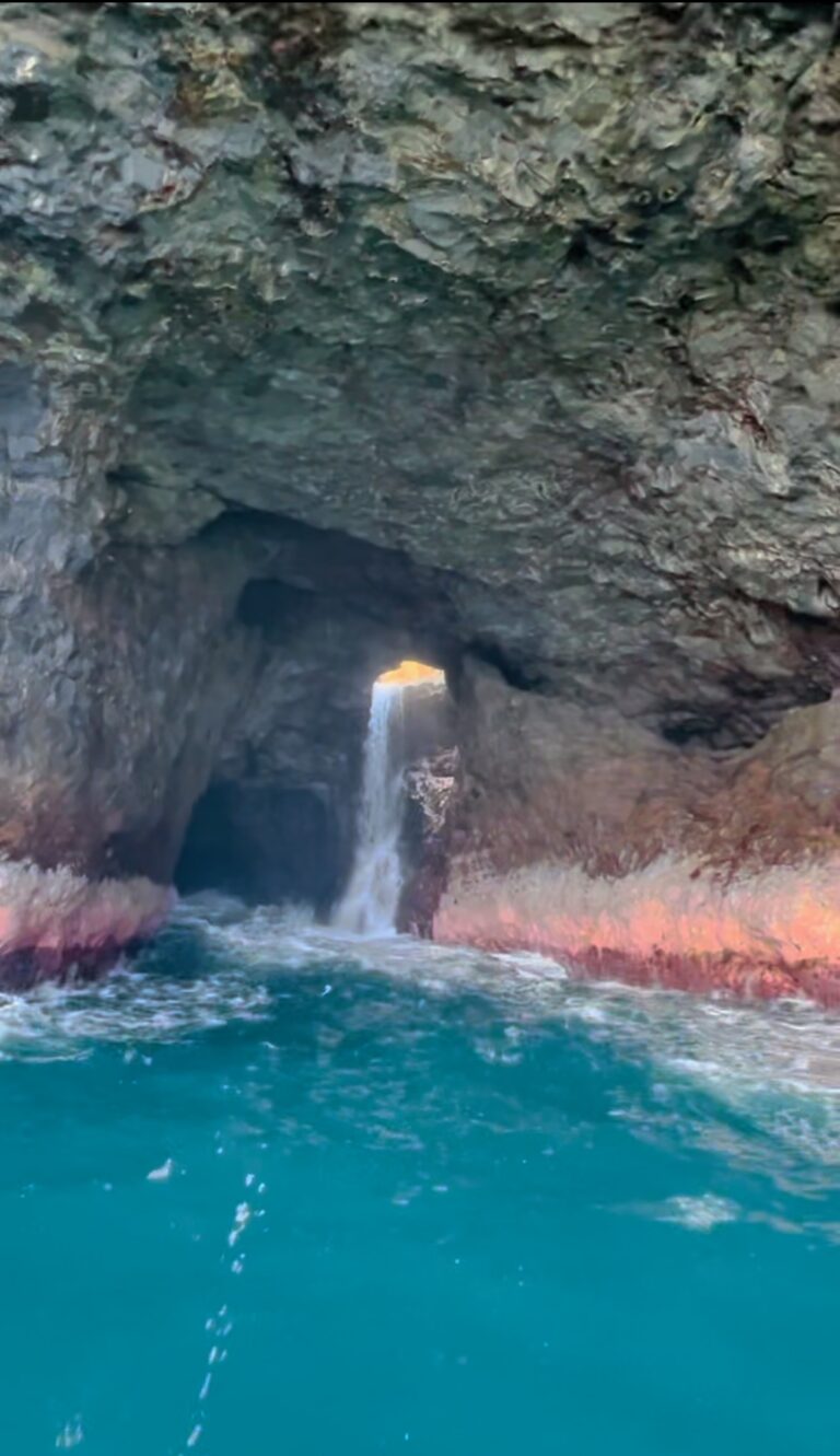 The tallest waterfall in Kauai ends in this sea cave along the Na Pali Coast