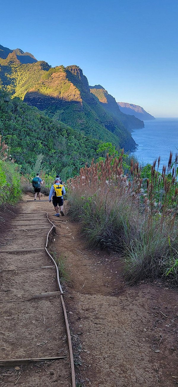 Hiking the Kalalau Trail with views of Na Pali Coast in Background