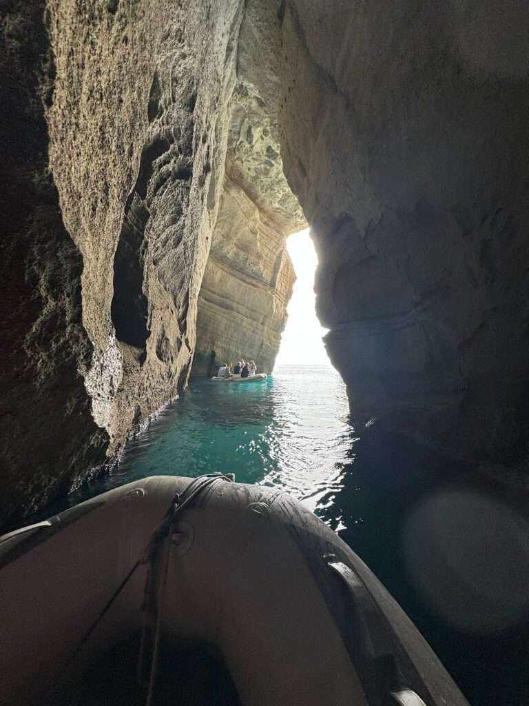 Exploring sea caves on a boat tour to Kleftiko in Milos, Greece